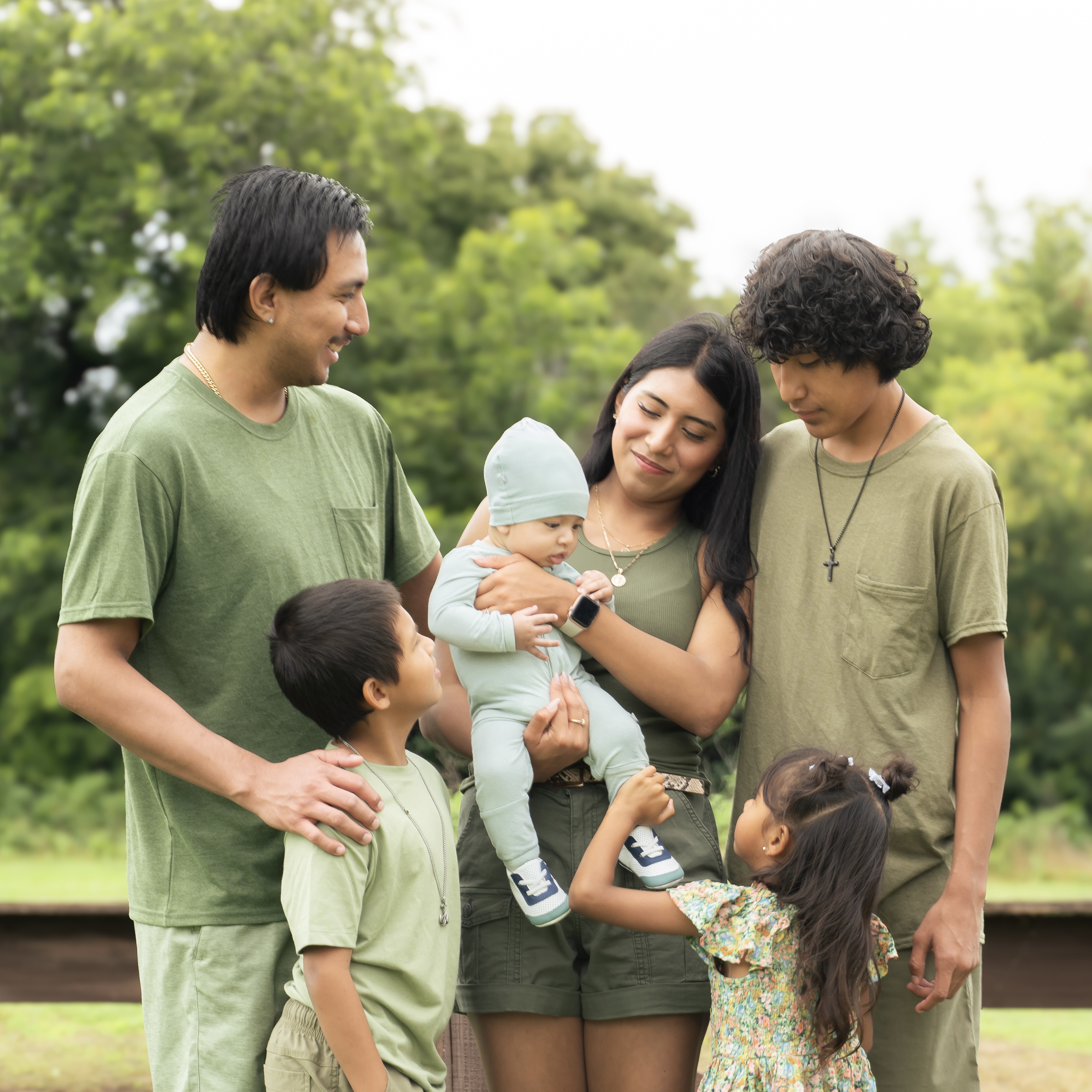 A toddler laughing on her dad's shoulders during a family session